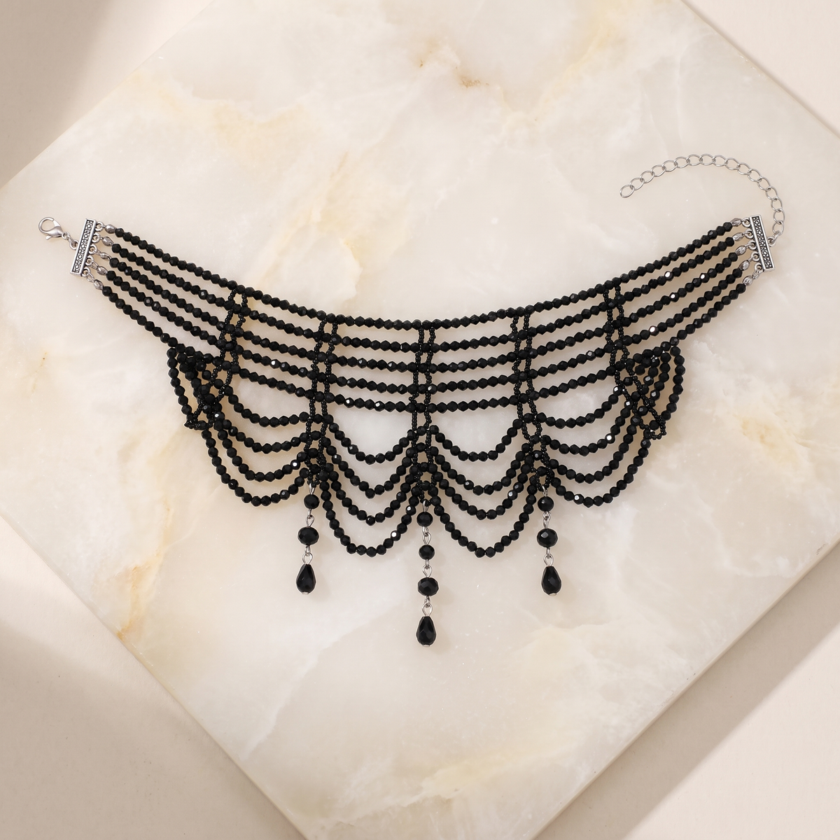 Rhinestone Cascade Collar in black — laid flat, showing clasp and extension chain